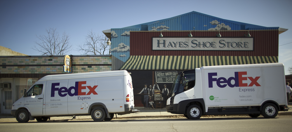 On the left, a conventional FedEx delivery vehicle compared to the eStar electric vehicle on the right. FedEx is testing the eStar in select urban markets.