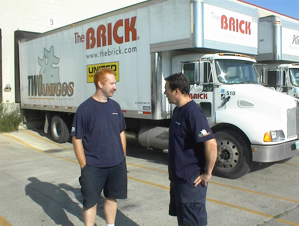 By switching to automated transmissions on its medium duty trucks, delivery fleet and moving company Two Amigos of Winnipeg, Canada, has effectively eliminated driver-related clutch and transmission issues. Cameron Quinn, driver (left) with fleet manager Brad Prociuk (right).