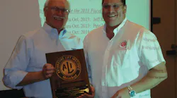 ALI President R.W. (Bob) O’Gorman, right, presents a service plaque to outgoing ALI Chairman Douglas Grunnet at the organization’s recent annual meeting.