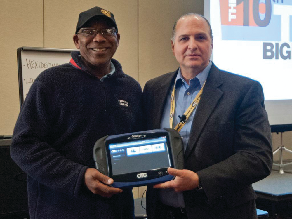 Norman Tennant being presented with an OTC Genisys Touch by TST president G 'Jerry' Truglia.