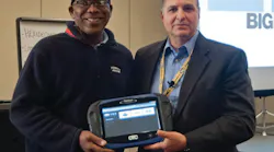 Norman Tennant being presented with an OTC Genisys Touch by TST president G 'Jerry' Truglia.