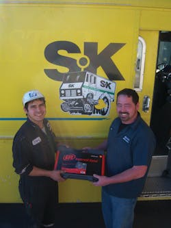 Clint Maxwell, right, gives an Ingersoll Rand air hammer to a customer at a shop that services oil tankers. Clint Maxwell, right, gives an Ingersoll Rand air hammer to a customer at a shop that services oil tankers.