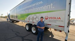 Electronics Recycling Division&apos;s fleet manager Michael Bomgardner holds the Zonar 2010 inspection tool which his drivers use as an electronic vehicle inspection reporting solution for pre- and post-trip inspections.