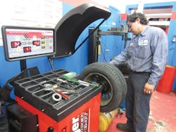 Mejia reported that set-up with the Ranger DST64T wheel balancer was a breeze. The user simply pulls out the arms to the left and right of the balancer and touch the rim snugly. They automatically input the tire height, width and rim size. In this picture, Mejia is placing the arm to the right of the balancer on the rim. After use, it snaps back into place. Mejia reported that set-up with the Ranger DST64T wheel balancer was a breeze. The user simply pulls out the arms to the left and right of the balancer and touch the rim snugly. They automatically input the tire height, width and rim size. In this picture, Mejia is placing the arm to the right of the balancer on the rim. After use, it snaps back into place.