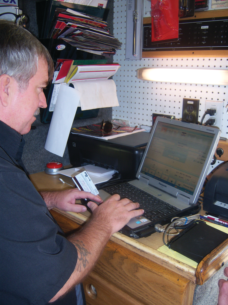 Bill Jaynes rings up a sale using a customer's credit card.