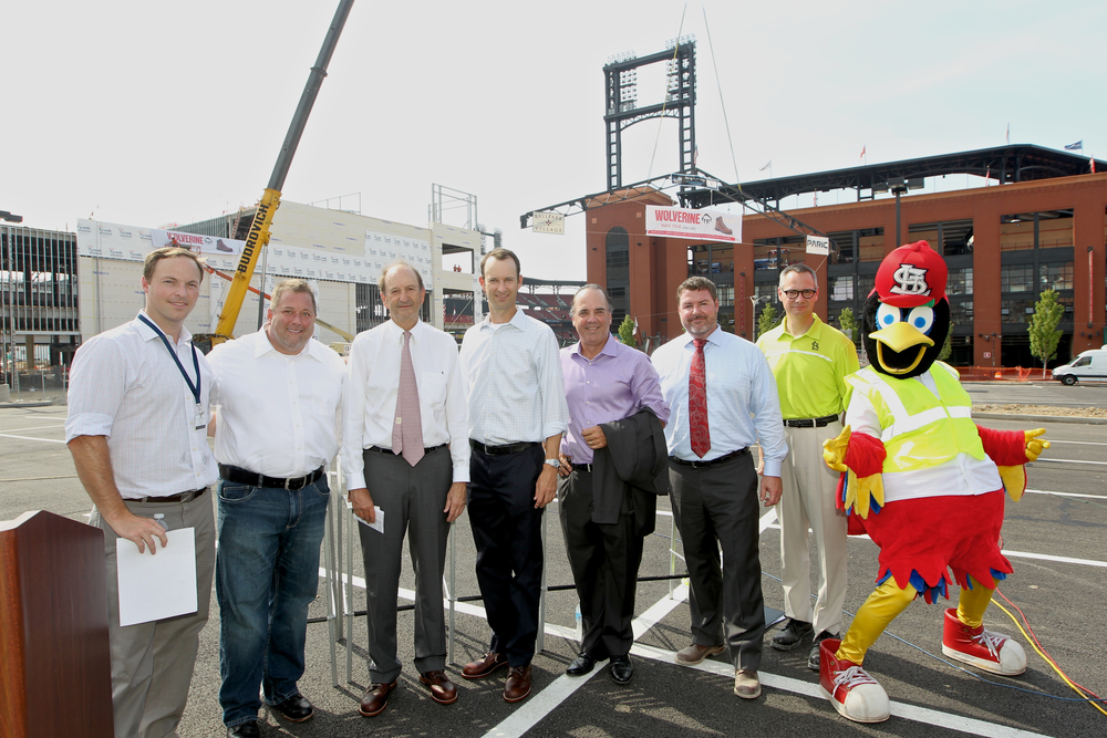 At St. Louis Ballpark VIllage topping off ceremony, event emcee, Todd Yates, President of Wolverine celebrates a construction milestone with Bill DeWitt III, President of the Cardinals, Chase Martin, Ballpark Village Director of Development, Keith Walkoff, President of Paric along with other civic officials and project partners.