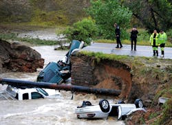 Officials investigate the scene of a road collapse at Highway 287 and Dillon at the Broomfield/Lafayette border, Colo., that sent three vehicles into the water after flash flooding on Thursday, Sept. 12, 2013. The National Weather Service has warned of an 'extremely dangerous and life-threatening situation' throughout the region. (AP Photo/Daily Camera, Cliff Grassmick) Officials investigate the scene of a road collapse at Highway 287 and Dillon at the Broomfield/Lafayette border, Colo., that sent three vehicles into the water after flash flooding on Thursday, Sept. 12, 2013. The National Weather Service has warned of an 'extremely dangerous and life-threatening situation' throughout the region. (AP Photo/Daily Camera, Cliff Grassmick)
