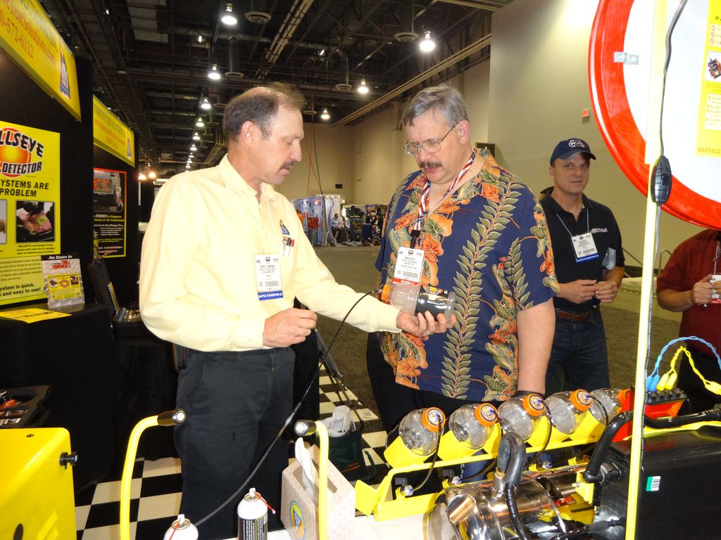 Bernie Thompson, left, of Automotive Test Solutions shows the Bullseye leak detector system, which can detect small leaks, at the 2013 AAPEX show.