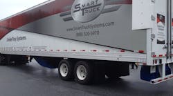 This photo shows three of the four aerodynamic device components that fleets can equip on their trailers. The undertray (blue) at the bottom middle of the trailer, the rear diffuser (blue) at the bottom back of the trailer, and the AeroEdge side fairings (white) at the top back part of the trailer. This photo shows three of the four aerodynamic device components that fleets can equip on their trailers. The undertray (blue) at the bottom middle of the trailer, the rear diffuser (blue) at the bottom back of the trailer, and the AeroEdge side fairings (white) at the top back part of the trailer.