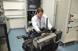 A TARDEC engineer integrates a hydrogen fuel cell onto a small tracked robot in the Fuel Cell lab at the GSPEL. A TARDEC engineer integrates a hydrogen fuel cell onto a small tracked robot in the Fuel Cell lab at the GSPEL.