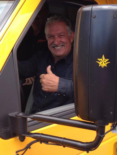 Most recent investor Gary Magness gives a thumbs-up while driving the Trans Tech Bus SST-e all-electric school bus, powered by Motiv Power Systems.