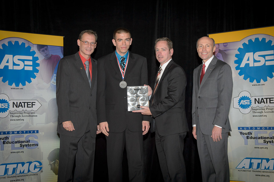 (L-R): Glenn Dahl, ASE chairman of the board of directors; Joseph Grenchik, Technician of the Future; Nick DiVerde, senior marketing director, Mitchell 1; Tim Zilke, ASE president & CEO.