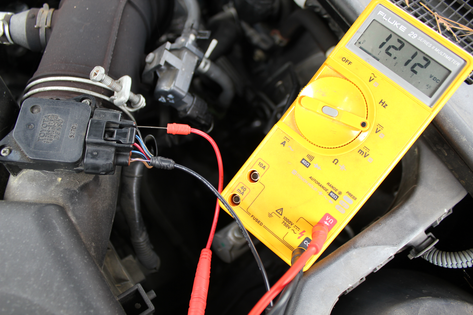 Using needle back probes to measure mass air flow sensor supply voltage live.