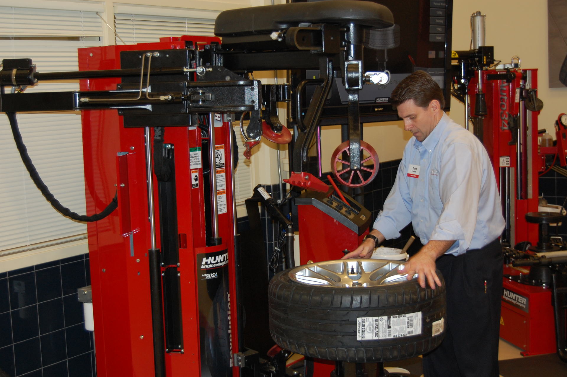 Hunter Engineering Director of Training Tom Settle demonstrates the features of the Hunter Revolution tire changer.