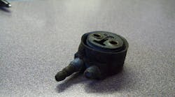 A corroded lamp connector shows signs of environmental stress and systemic corrosion.
