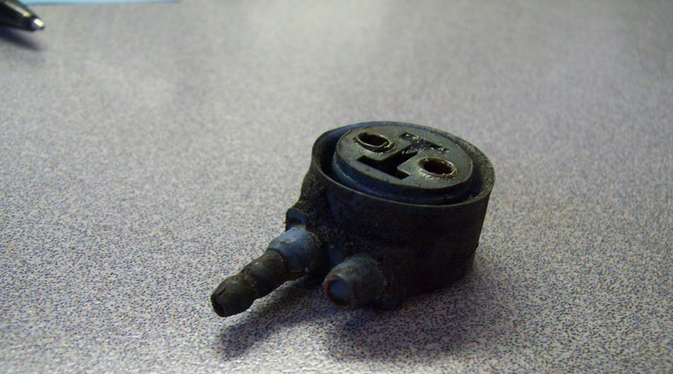 A corroded lamp connector shows signs of environmental stress and systemic corrosion.