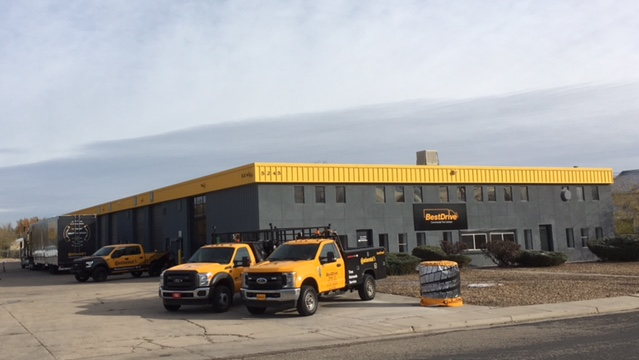 BestDrive Denver commercial tire and service center with roadside service trucks.