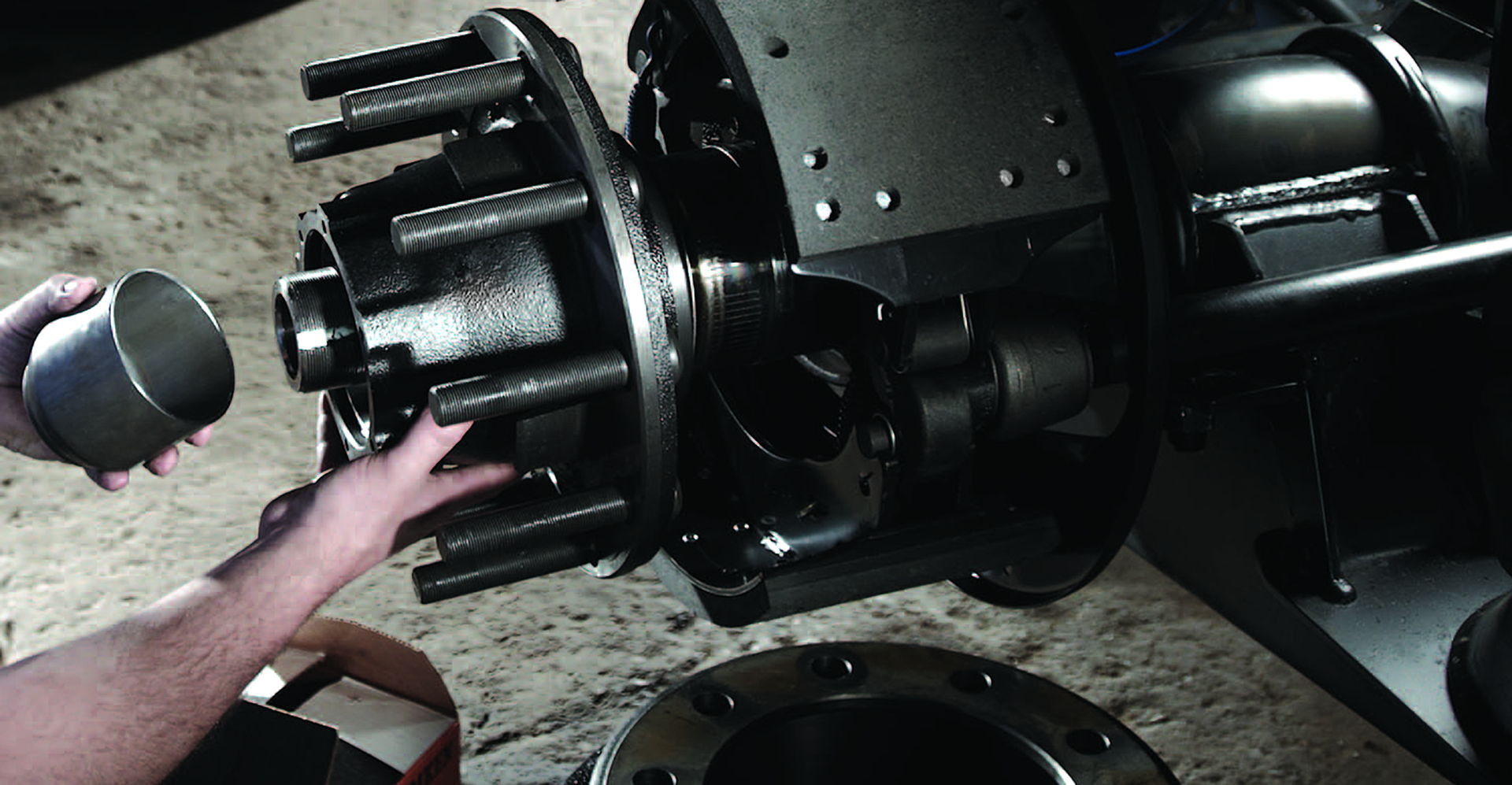 Here a technician installs a pre-set spacer to a pre-adjusted wheel end system. Pre-adjusted wheel-end systems provide a preset amount of preload during component assembly by the manufacturer.
