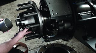 Here a technician installs a pre-set spacer to a pre-adjusted wheel end system. Pre-adjusted wheel-end systems provide a preset amount of preload during component assembly by the manufacturer.
