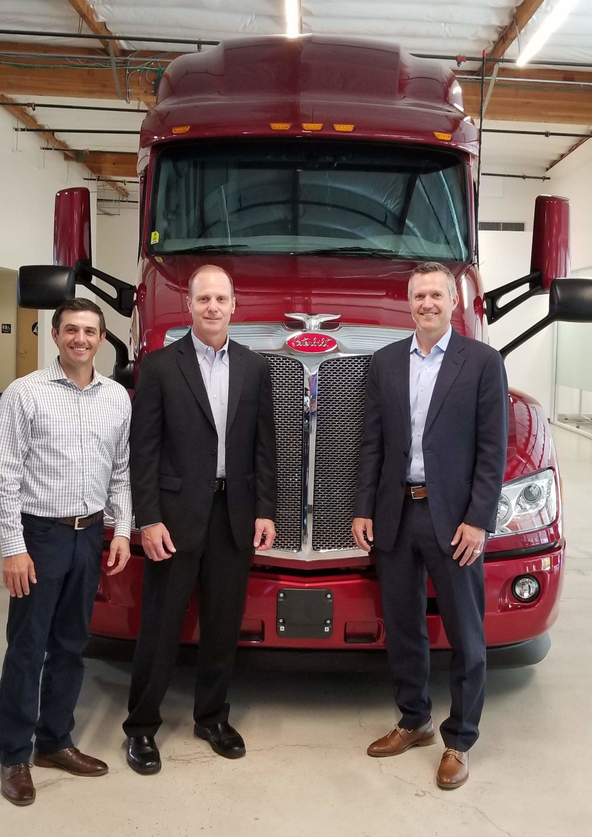 (Left to right) Jake Monetero, Paccar Innovation Center general manager; Scott Newhouse, Peterbilt chief engineer; and Jason Koog, Peterbilt general manager, pose with a Peterbilt at the Paccar Innovation Center in Sunnyvale, Calif.