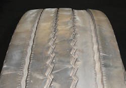 (SECTION 2: Irregular trailer tire conditions) 1. Depression Wear (Intermediate) Appearance: One or more interior ribs (not center) worn below adjacent ribs around the tire’s circumference. Probable Cause: Worn suspension components, mismatched dual diameter or inflation pressures, underinflation, improper bearing adjustment. Aggravated by high speed/light loads. Corrective Action: Diagnose mechanical condition and correct. Tire Disposition: Continue to run until pull point, then retread. (SECTION 2: Irregular trailer tire conditions) 1. Depression Wear (Intermediate) Appearance: One or more interior ribs (not center) worn below adjacent ribs around the tire’s circumference. Probable Cause: Worn suspension components, mismatched dual diameter or inflation pressures, underinflation, improper bearing adjustment. Aggravated by high speed/light loads. Corrective Action: Diagnose mechanical condition and correct. Tire Disposition: Continue to run until pull point, then retread.
