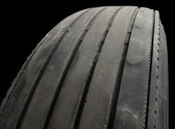 (SECTION 2: Irregular trailer tire conditions) 4. Depression Wear (Shoulder) Appearance: Localized areas of wear in shoulder, generally less than 12” in length. Probable Cause: Improper inflation pressure or tire mismounted on wheel. Can also be caused by some other type of wheel-end imbalance. Corrective Action: Review tire and wheel-end maintenance practices. Tire Disposition: Continue to run until pull point, then retread. (SECTION 2: Irregular trailer tire conditions) 4. Depression Wear (Shoulder) Appearance: Localized areas of wear in shoulder, generally less than 12” in length. Probable Cause: Improper inflation pressure or tire mismounted on wheel. Can also be caused by some other type of wheel-end imbalance. Corrective Action: Review tire and wheel-end maintenance practices. Tire Disposition: Continue to run until pull point, then retread.