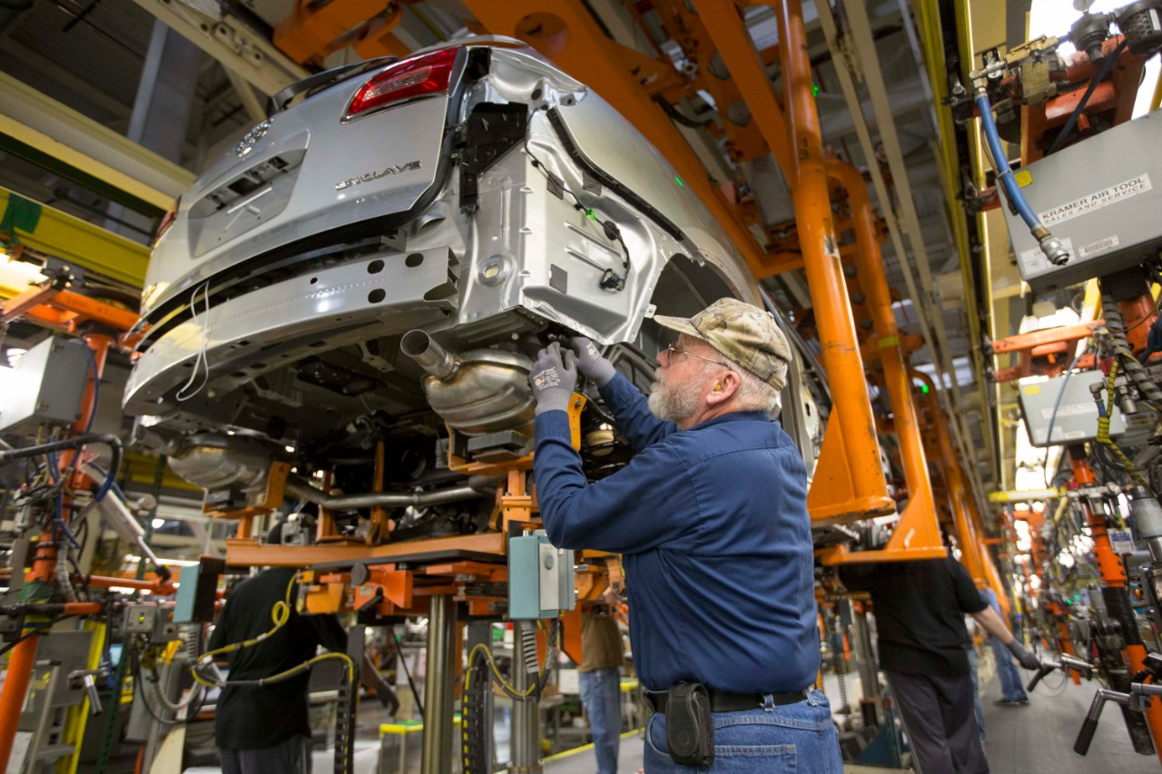 Greg Middleton, a GM employee for 28 years, marries the chassis to the body of a 2015 Buick Enclave in 2015 at the General Motors Lansing Delta Township Assembly plant. (The assembly plant pictured here will remain in production in 2019.)
