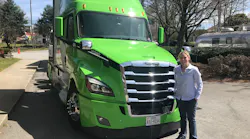 Standing in front of the retrofit Hyllion hybrid-electric Class 8 tractor, during a press event in Atlanta.