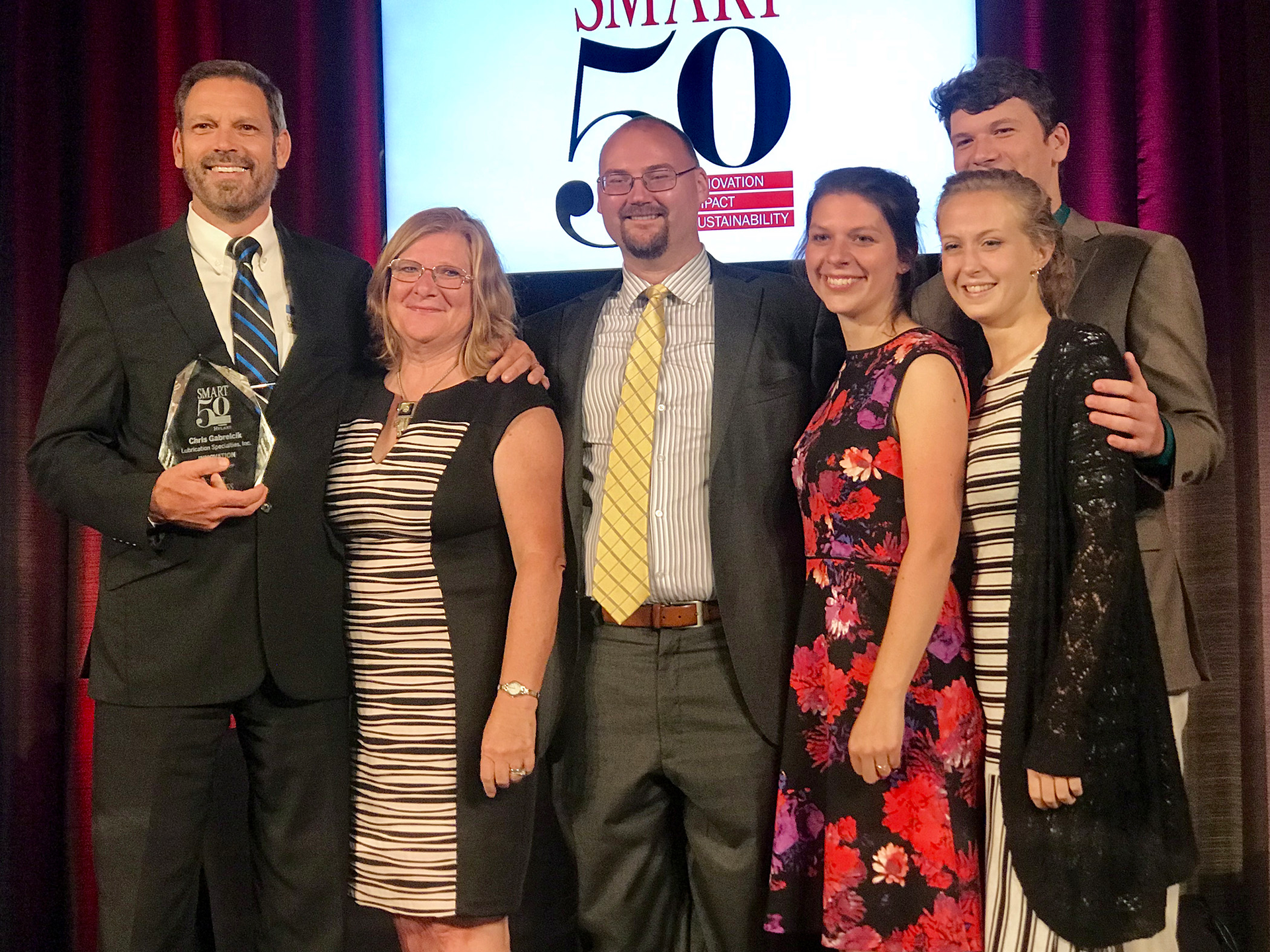 LSI President and Founder Chris Gabrelcik accepts the Smart 50 Award for Innovation, sponsored by Smart Business Magazine, with members of his family.