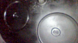 In this image, a technician is looking up at the valves in a diesel engine using a Vividia D3145 articulating camera.