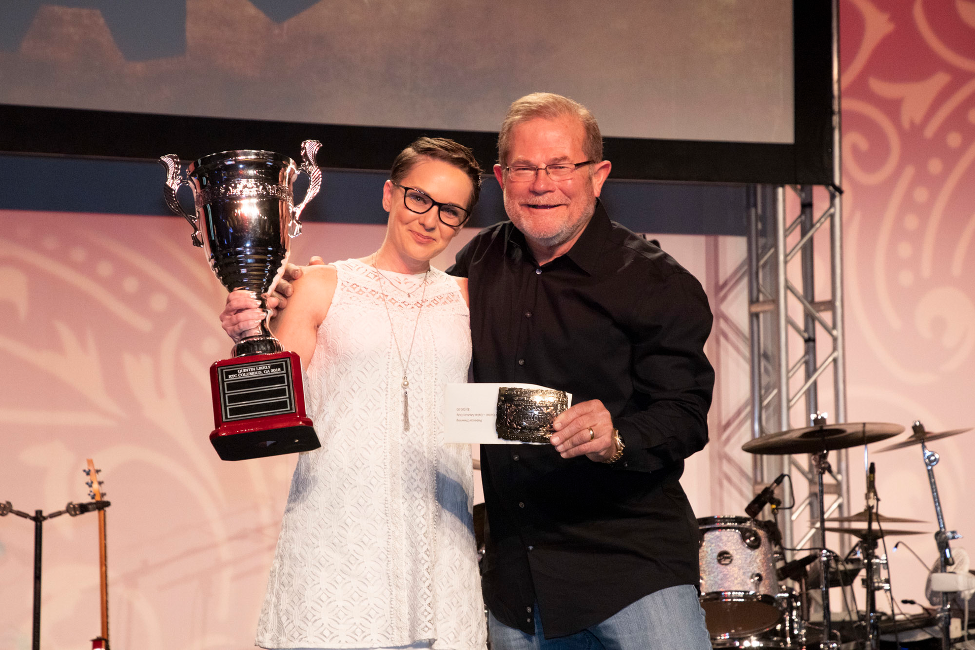 Rebecca Chewning receiving her trophy for All-Around Grand Champion of the Hino parts division from 'Rusty' Rush.