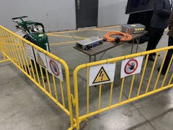 Volvo has evaluated the tools, equipment, and processes necessary to service heavy duty trucks in the shop. Pictured here are items such as proper signage and high-visibility safety barriers as well as lockout / tagout lockboxes used on the traction voltage system, which includes 600V orange cables that can cause severe electric shock if not managed properly.