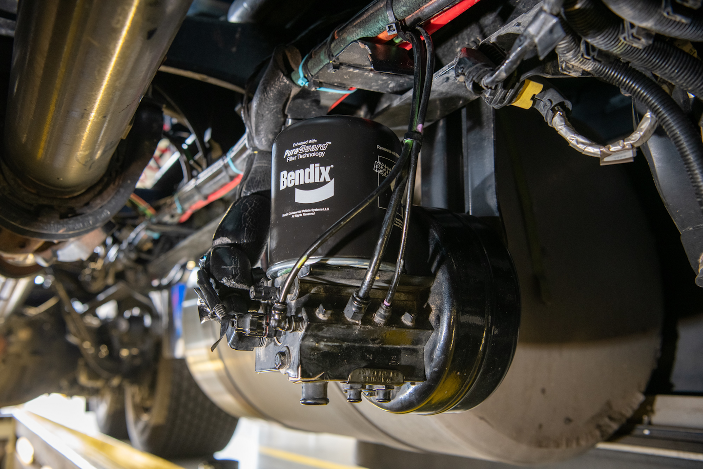 Pictured is a Bendix AD-IS dryer with PuraGuard oil-coalescing filter mounted on a truck. Oil-coalescing filters are essential for trucks with AMTs due to an AMTs’ need for extremely high-quality air.