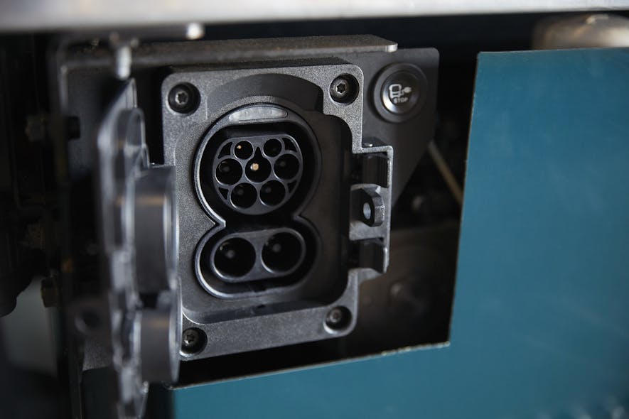 The CCS2 connector and charging port location on the Volvo VNR Electric truck model.