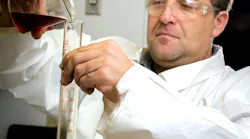 Kevin Adams, vice president of research and development, LSI Chemical, tests a new LSI Chemical oil additive.