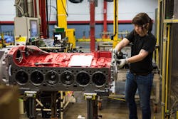 A Cummins worker at the Jamestown Engine Plant in Jamestown, New York, assembles a X12 engine, which was launched in 2018 to offer customers a more modest displacement (11.8L) than the X15 (14.9L). The X12 is currently available with Freightliner, Western Star, Autocar, Oshkosh, Terex, and several other specialty truck manufacturers.