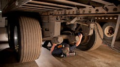 Technicians should look for worn paint or rust underneath fasteners during inspection, which is indicative of a loose fastener allowing movement. Steam cleaning the chassis, removing dirt and grime, allows for a clear visual inspection of all suspension components.
