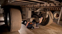 Technicians should look for worn paint or rust underneath fasteners during inspection, which is indicative of a loose fastener allowing movement. Steam cleaning the chassis, removing dirt and grime, allows for a clear visual inspection of all suspension components.