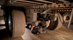 Technicians should look for worn paint or rust underneath fasteners during inspection, which is indicative of a loose fastener allowing movement. Steam cleaning the chassis, removing dirt and grime, allows for a clear visual inspection of all suspension components.