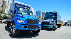 International’s eMV, left, and Freightliner’s eM2, battery-electric medium-duty trucks on display at ACT Expo 2022 in Long Beach, California.