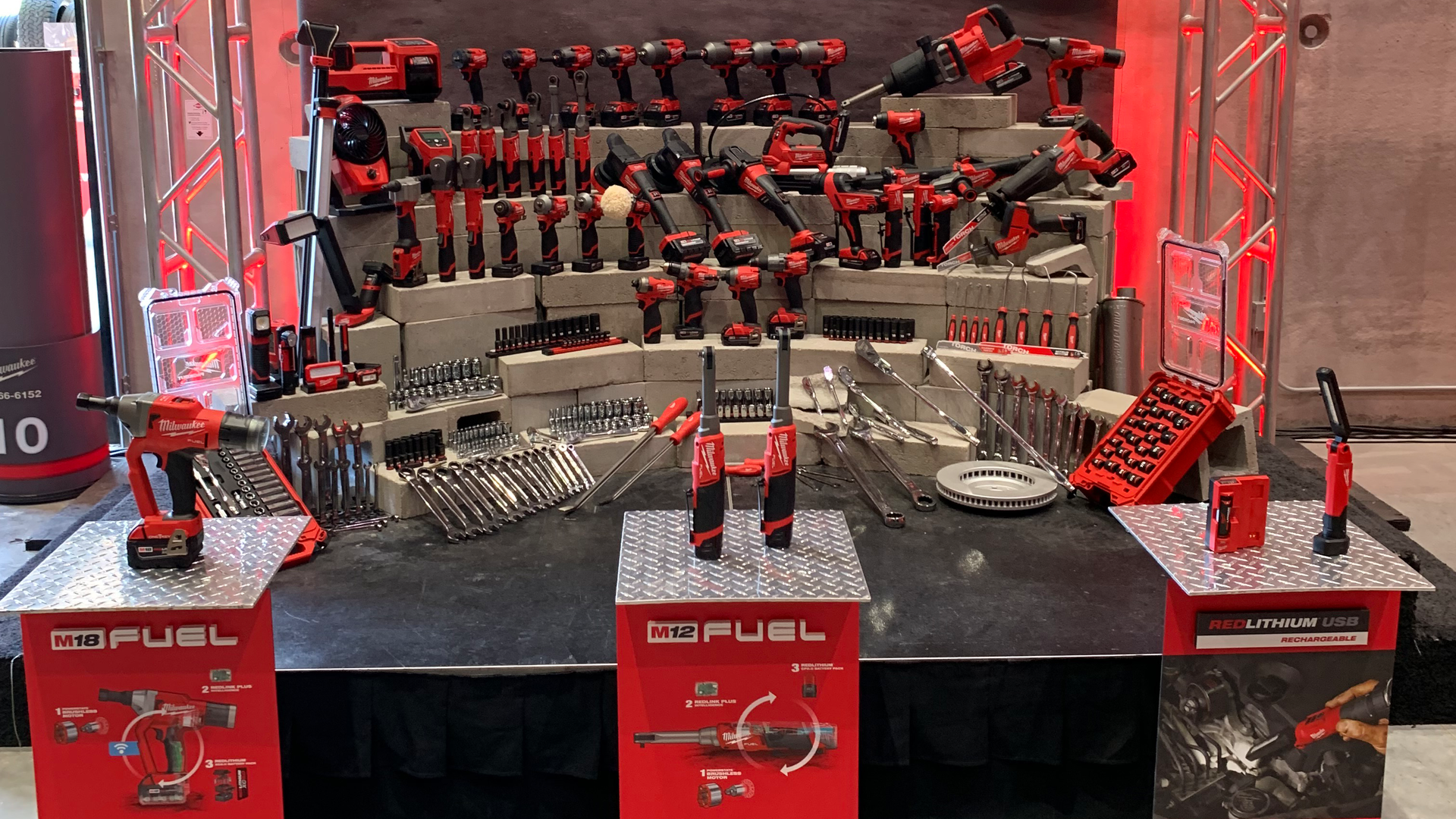 During Pipeline 2022, Milwaukee Tool announced three new products for automotive technicians: the M18 Fuel 1/4' Lockbolt Tool with One-Key (left), the M12 Fuel 3/8' and 1/4' Extended Reach High Speed Ratchets (center), and the REDLITHIUM USB Stick Light with Magnet (right). Behind the new products is an array of the company's automotive tooling solutions.