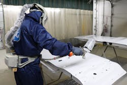 Fleet Fast's Francisco Esquivel dons his painting suit to apply a clear coat. Fleet Fast's Francisco Esquivel dons his painting suit to apply a clear coat.