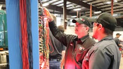 An instructor at NVI-Blairsville teaches a student how to diagnose wire harness issues.