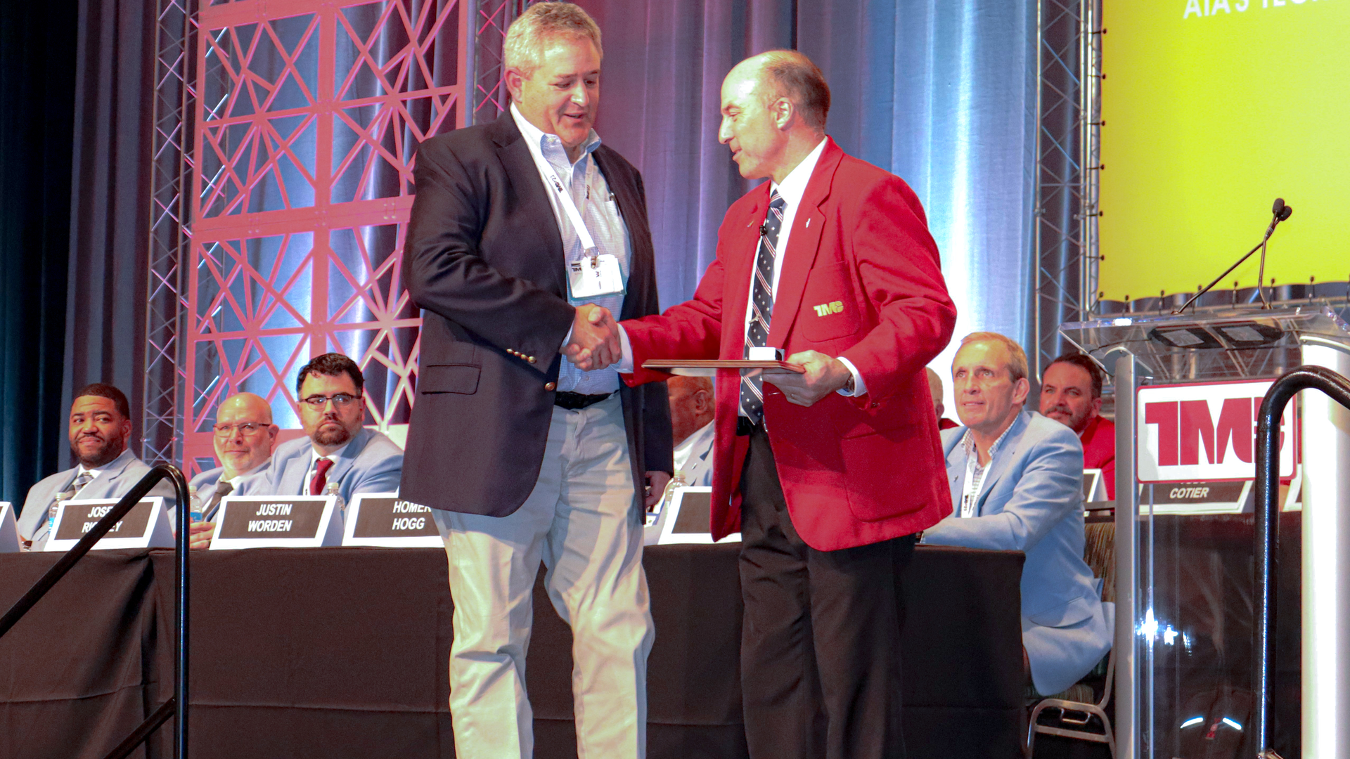 Randy Obermeyer, TMC general chairman, at right, presents Matt Jablon, district service director for Daimler Truck North America, with a Silver Spark Plug award Monday during TMC's 2023 Annual Meeting in Orlando, Florida.