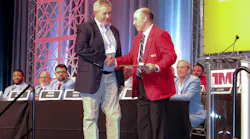 Randy Obermeyer, TMC general chairman, at right, presents Matt Jablon, district service director for Daimler Truck North America, with a Silver Spark Plug award Monday during TMC's 2023 Annual Meeting in Orlando, Florida.