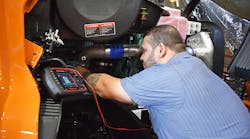 A technician from A. Duie Pyle performs diagnostics on a truck.