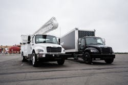 The new eM2 on-highway truck (right) is available in Class 6 and Class 7 configurations. Freightliner also is expanding the eM2 medium-duty truck for vocational applications (left), with utility applications among the first vocational offerings.