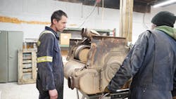 Shop owner Ryan Fox (left) looks over a Detroit 1-box aftertreatment unit. At right is Fox&rsquo;s co-worker and uncle, Chris Fox.