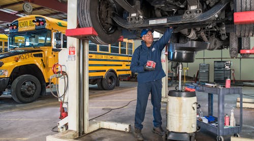 Boston Public Schools&apos; mechanic performs routine maintenance on one of the district&apos;s propane buses.