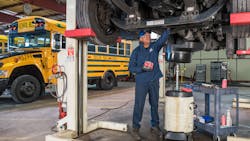 Boston Public Schools' mechanic performs routine maintenance on one of the district's propane buses. Boston Public Schools' mechanic performs routine maintenance on one of the district's propane buses.